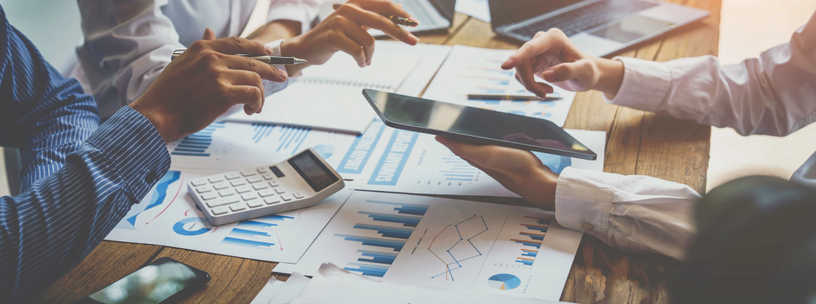 Photo of people meeting at a table strategizing and planning.