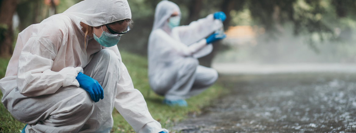 Groundwater Testing Two scientists in protective suits taking water samples from the river.
