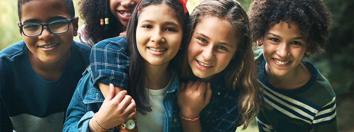 Child Youth and Family Services youth outdoors Shot of a group of teenagers embracing in nature at summer camp