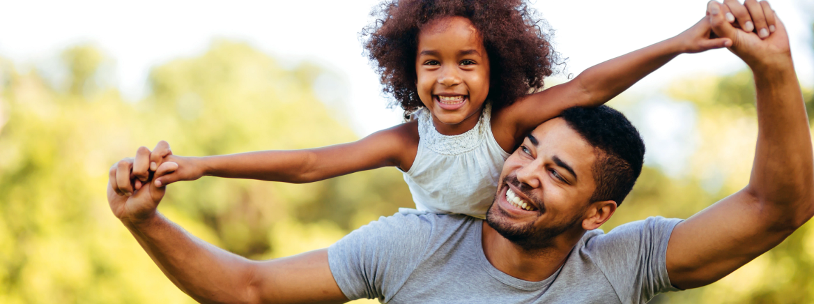 Header - Empowering Fatrhers Father holding Daughter piggy back