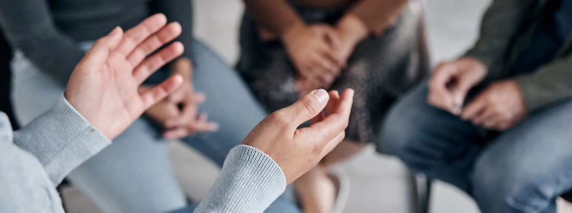 People sitting in a circle for mental health group therapy