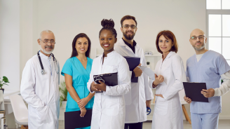 Group portrait of diverse multiethnic doctors in medical uniform pose in clinic. Smiling multiracial medicine workers or professionals show good health service in hospital. Healthcare concept.