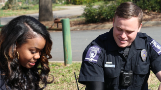 A photo of a police officer with a woman.