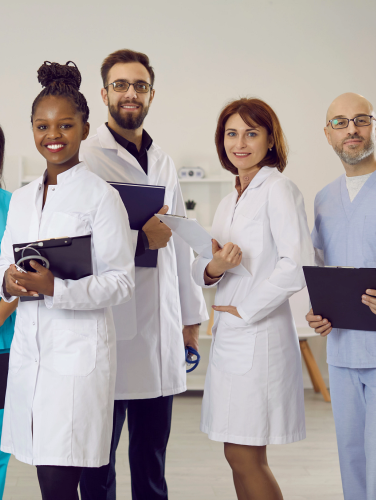 Group portrait of diverse multiethnic doctors in medical uniform pose in clinic. Smiling multiracial medicine workers or professionals show good health service in hospital. Healthcare concept.