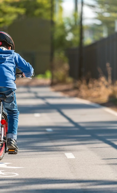Australian boy riding his bicycle on bike lane on a day, South Australia