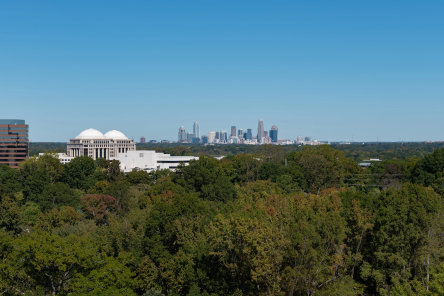 Charlotte skyline photographed from a distance with green tree coverage seen for miles.