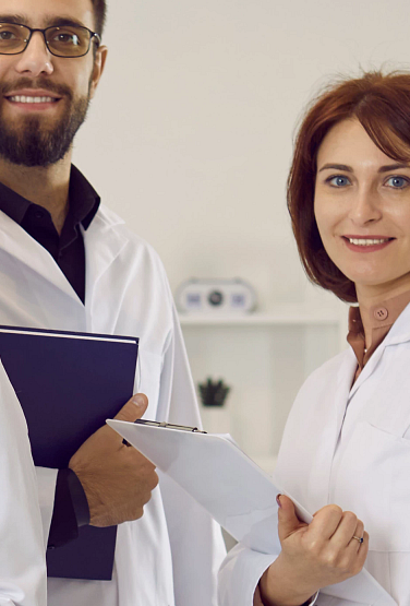 Group portrait of diverse multiethnic doctors in medical uniform pose in clinic. Smiling multiracial medicine workers or professionals show good health service in hospital. Healthcare concept.
