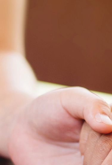photo of a woman holding a man's hand